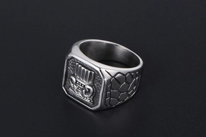 Detail of silver signet ring with vintage scroll pattern and textured scale engraving