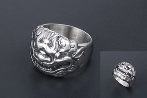 Macro shot of retro stainless steel ring featuring detailed mythical beast relief carvings