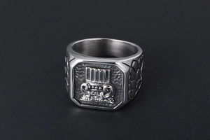 Macro view of men's titanium steel signet ring with engraved column and stone texture