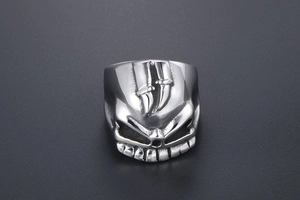 Macro shot of punk style stainless steel skull ring with embossed twin sword detail