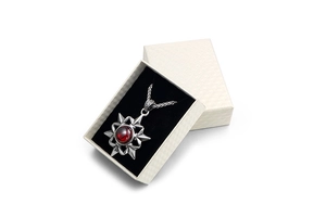 Vintage star pendant necklace with red gemstone in a premium beige textured jewelry gift box
