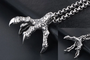 Macro detail of gothic punk silver dragon claw pendant on rugged steel chain link
