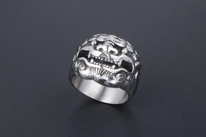 Detail macro view of a vintage titanium steel men's ring with a lion head relief design
