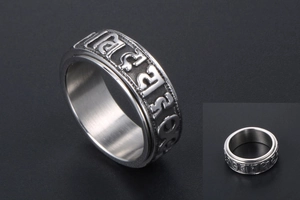 Macro detail of rotating stainless steel spinner ring with engraved Mantra characters