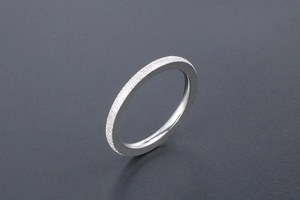 Detail view of silver titanium steel ring with matte finish exterior and polished inner band