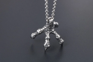 Macro shot of punk style stainless steel dragon claw pendant with detailed bionic texture