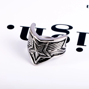 Detailed close-up of vintage titanium steel wide ring with star and wing textures
