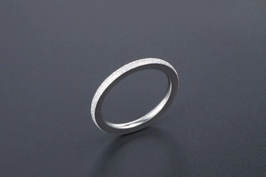 Detail view of matte frosted titanium steel ring with polished inner surface