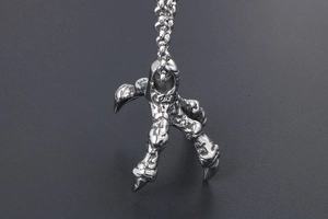 Detailed close-up of a punk style stainless steel dragon claw pendant necklace for men