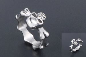 Macro shot of punk style skull and crossbones ring in polished stainless steel