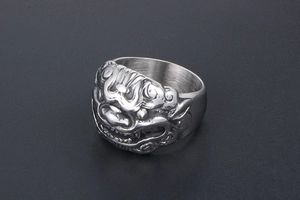 Macro shot of retro stainless steel ring with detailed Kylin beast carving and matte finish