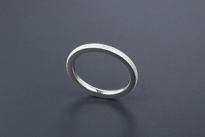 Detailed macro view of silver titanium steel ring with matte finish and polished inner band