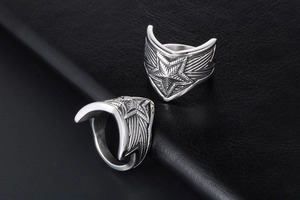 Macro shot of retro titanium steel star ring showing polished wing texture and details