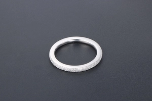 Detail of matte frosted surface texture on silver titanium steel minimalist rings