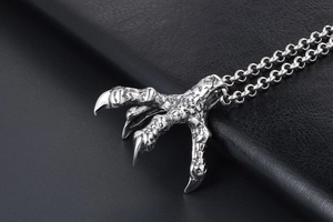 Detailed macro view of silver eagle claw pendant with punk style stainless steel chain