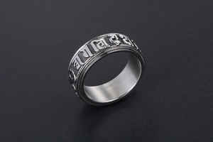 Detailed view of rotating stainless steel ring with embossed religious scriptures