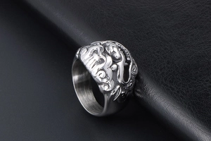 Macro shot of vintage titanium steel ring featuring embossed mythical Kirin relief design