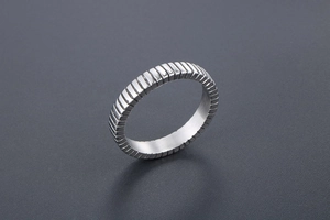 Detailed view of titanium steel ring with textured vertical grid pattern for men and women