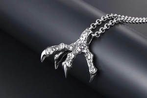 Macro detail of silver punk dragon claw pendant showing intricate bionic scale texture