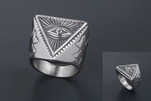 Macro shot of punk evil eye totem engraved on vintage stainless steel ring for men