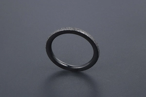 Macro shot of minimalist black matte titanium ring with polished inner surface