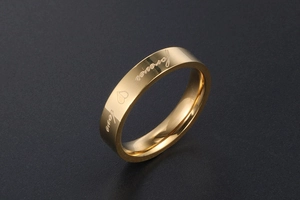 Detailed view of polished gold stainless steel ring with forever love engraving