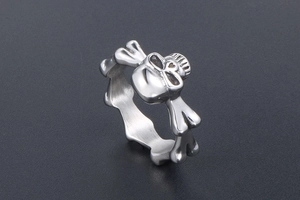 Macro detail of gothic skull and crossbones stainless steel ring with polished finish