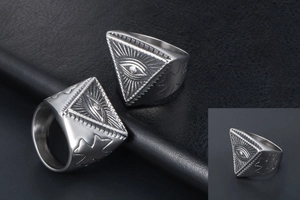 Macro detail of punk rock evil eye totem ring in silver stainless steel with vintage finish
