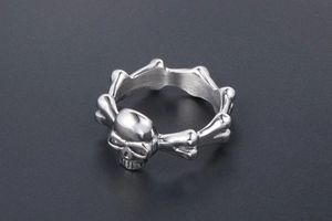 Detail view of punk skull ring featuring interlocking bone textures in vintage steel
