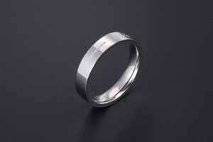 Close-up of silver titanium steel ring featuring engraved Forever text and heart symbol