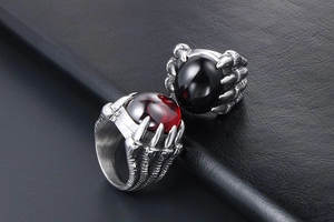 Détail macro de bague homme griffe de dragon vintage avec pierres rouges et noires
