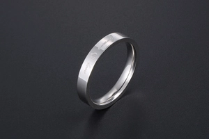 Detailed close-up of a polished silver ring with Forever Love and heart engraving