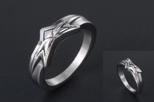 Macro shot of silver titanium steel star ring with brushed and polished geometric texture
