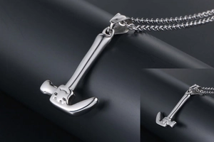 Close-up of a polished stainless steel mini hammer pendant with a delicate link chain
