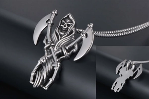 Detailed macro view of silver Grim Reaper pendant with dual scythes and metal ball chain