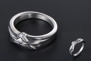 Macro view of silver star steel ring featuring geometric engraving and brushed finish