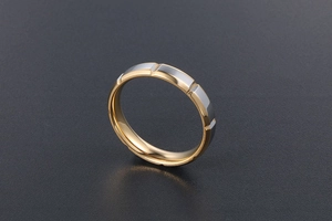 Macro d'une bague bicolore en acier inoxydable avec intérieur doré et extérieur argenté