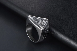 Macro side view of punk evil eye totem signet ring in vintage stainless steel finish