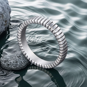 Titanium steel ring with vertical ribbed design set against a serene water and rock background