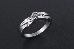 Detailed view of silver star steel ring with geometric star-shaped faceted design