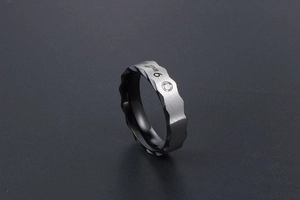 Macro shot of wavy edge titanium ring with silver brushed finish and black inner band