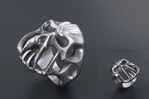 Detailed macro view of punk style skull mask ring with matte stainless steel texture