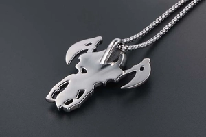 Macro detail of gothic grim reaper scythe pendant in polished silver stainless steel