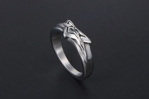 Macro shot of the geometric star relief on the silver titanium steel ring for men and women