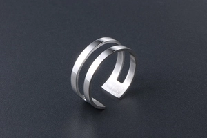 Detailed view of silver minimalist double-layer open ring with polished metal finish