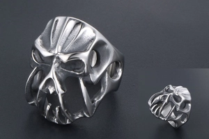 Macro shot of silver gothic skull ring with punk hollow engraving and metal texture