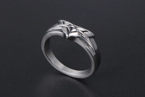 Macro shot of silver stainless steel star ring with 3D geometric cross design and polished finish