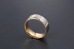 Vue détaillée d'une bague en acier titane bicolore avec rainures argentées et intérieur doré