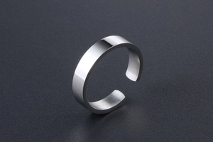 Macro view of polished silver steel ring showing smooth mirror finish and brushed inner metal