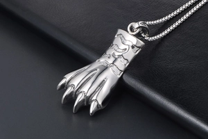 Détail du pendentif griffe d'ours argenté avec texture ondulée sur cuir noir élégant